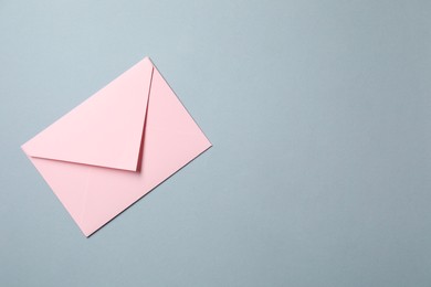 Photo of Letter envelope on grey background, top view. Space for text