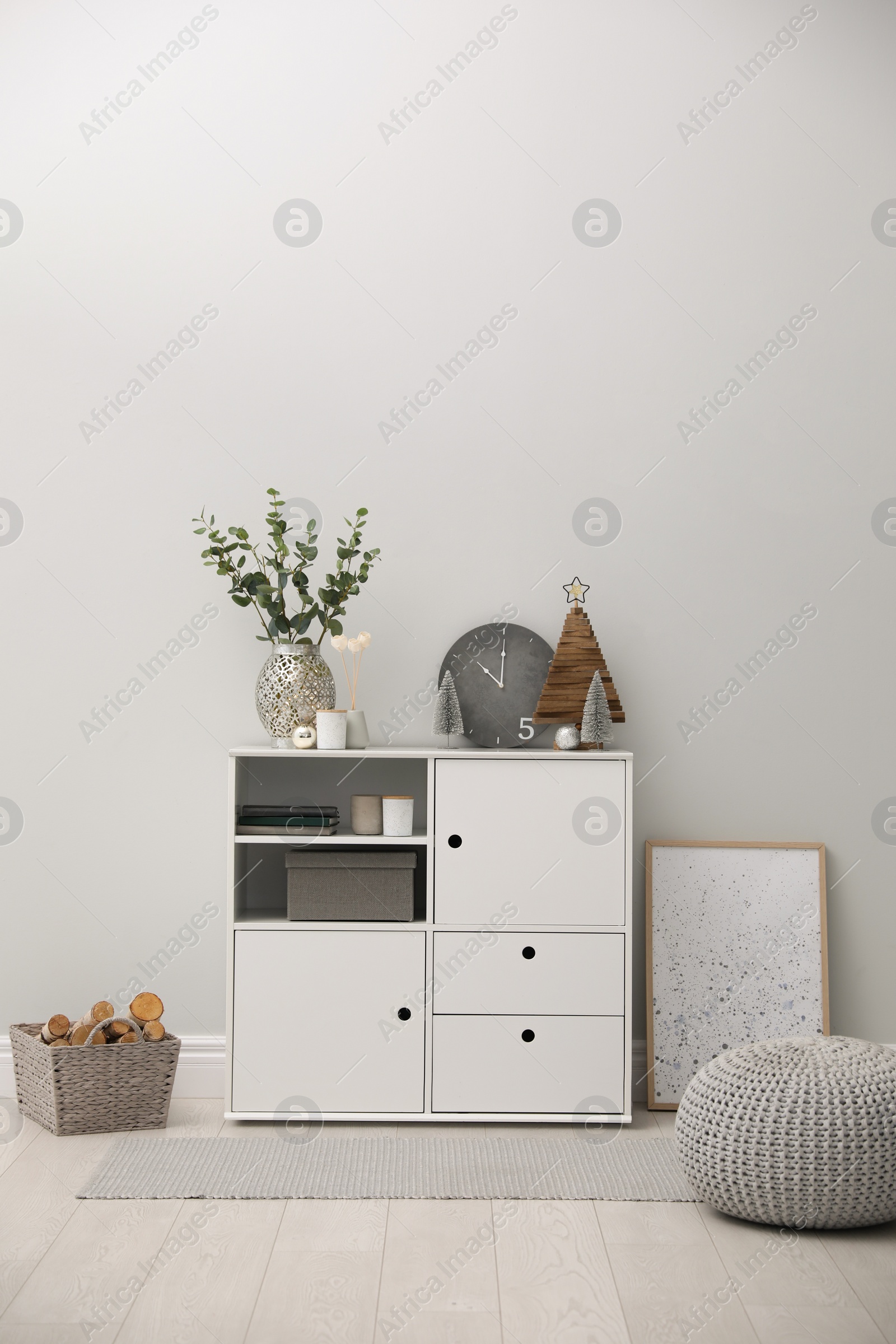 Photo of Modern room interior with white cabinet near light wall