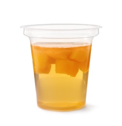 Photo of Tasty jelly dessert with slices of fruit in plastic cup on white background