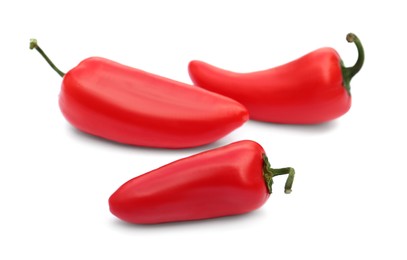 Photo of Fresh raw red hot chili peppers on white background