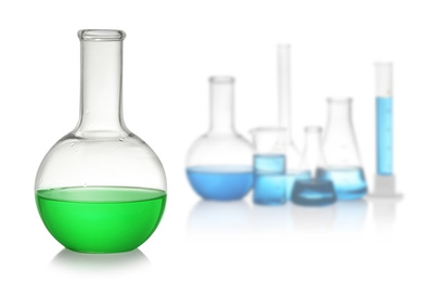 Image of Florence flask with green liquid near laboratory glassware on white background