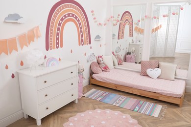 Photo of Montessori bedroom interior with floor bed and toys