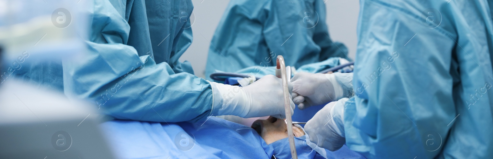 Image of Professional doctors performing frontal sinus trephination in surgery room, closeup. Banner design