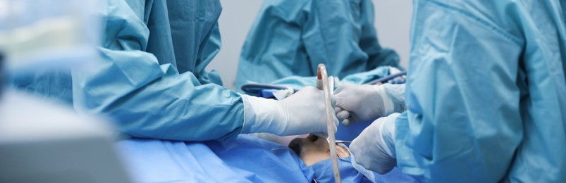 Image of Professional doctors performing frontal sinus trephination in surgery room, closeup. Banner design