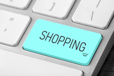 Image of Online store. Turquoise button with word SHOPPING on computer keyboard, closeup