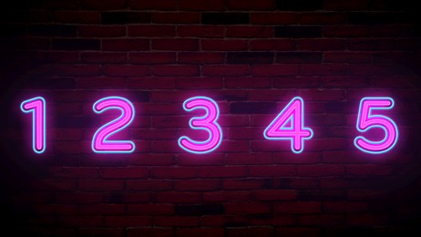 Image of Glowing neon number (1, 2, 3, 4, 5) signs on brick wall