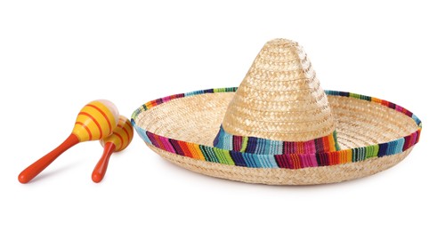 Photo of Mexican sombrero hat and maracas isolated on white