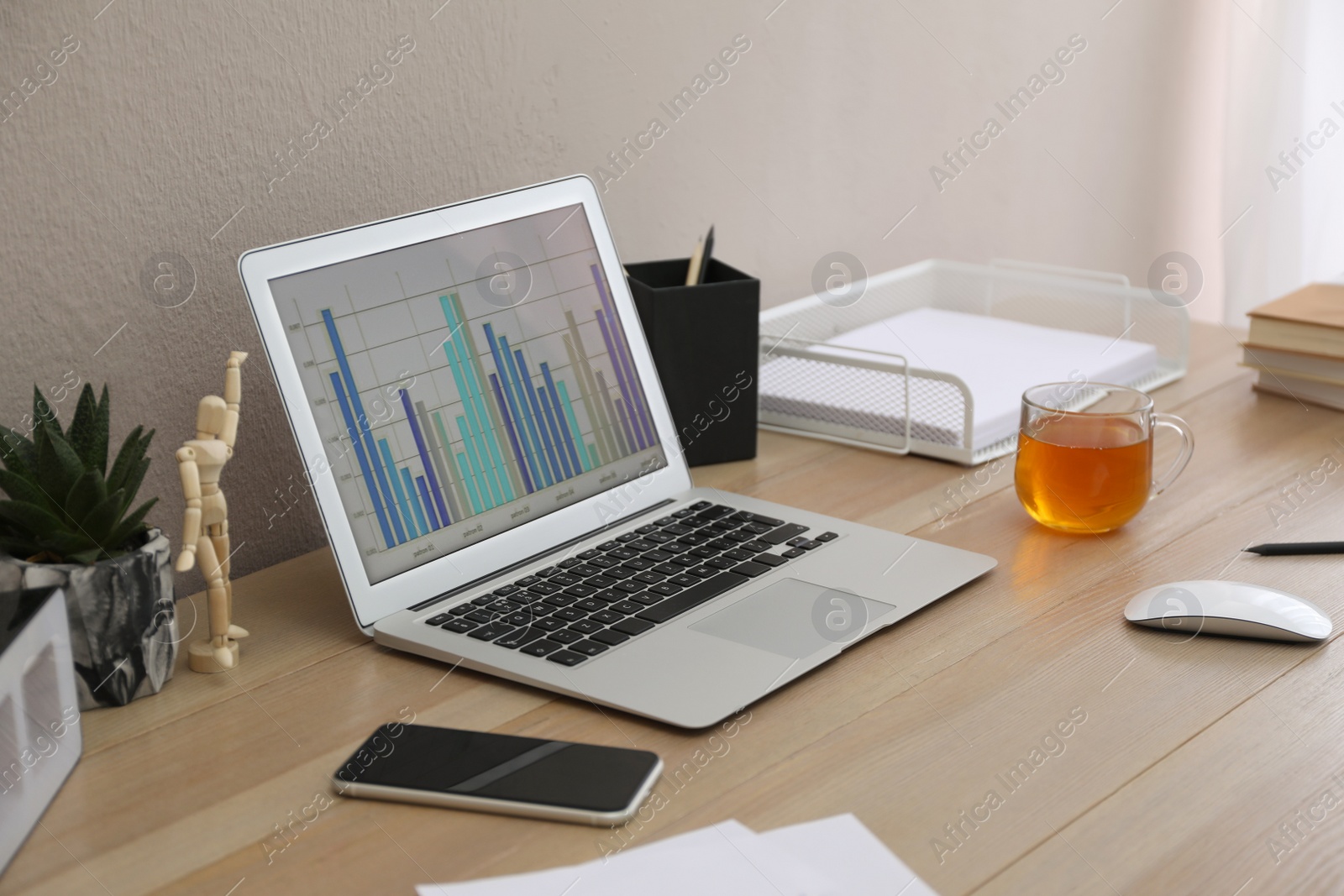 Photo of Stylish workplace with laptop on wooden desk. Interior design