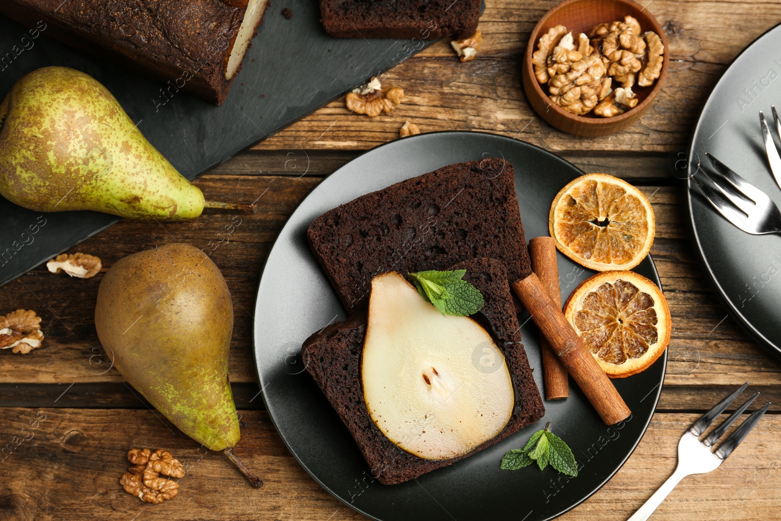 Photo of Flat lay composition with tasty pear bread on wooden table. Homemade cake