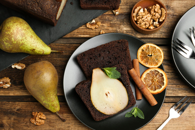 Photo of Flat lay composition with tasty pear bread on wooden table. Homemade cake