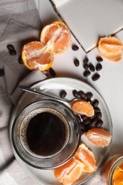 Flat lay composition with many fresh ripe tangerines and book on white wooden table