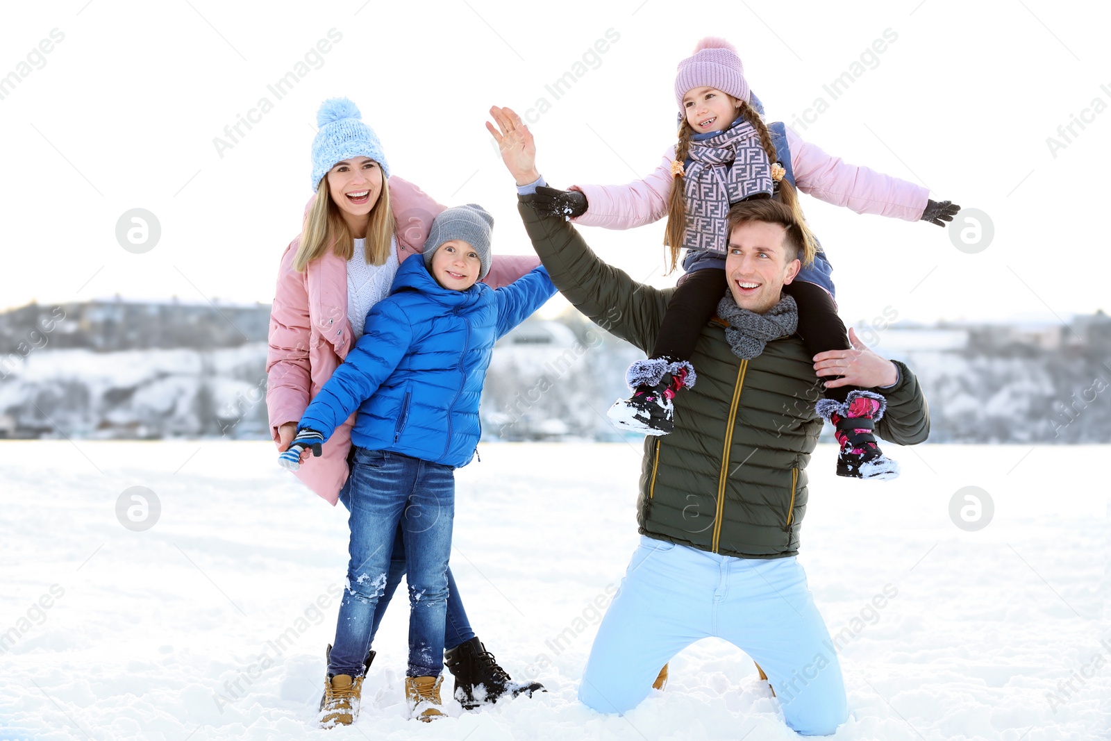 Photo of Portrait of happy family outdoors on winter day