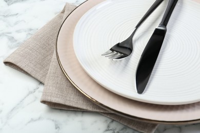 Clean plates, cutlery and napkin on table, closeup