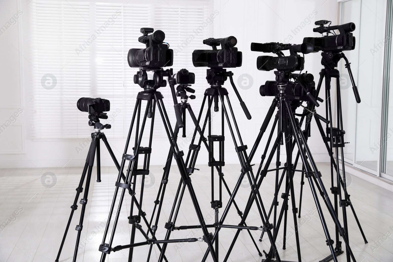 Photo of Modern video cameras indoors. Professional media equipment for broadcasting event