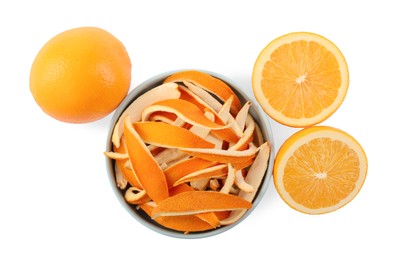 Bowl with dry orange peels and fresh fruits isolated on white, top view