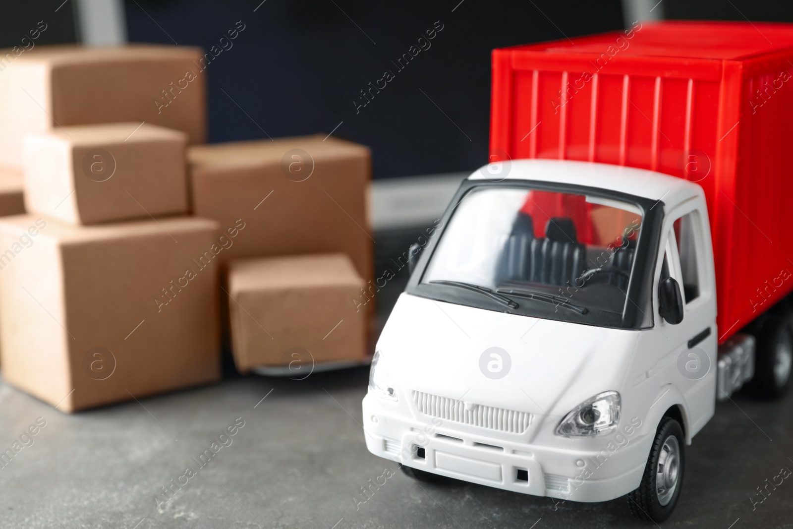 Photo of Toy truck on table. Logistics and wholesale concept