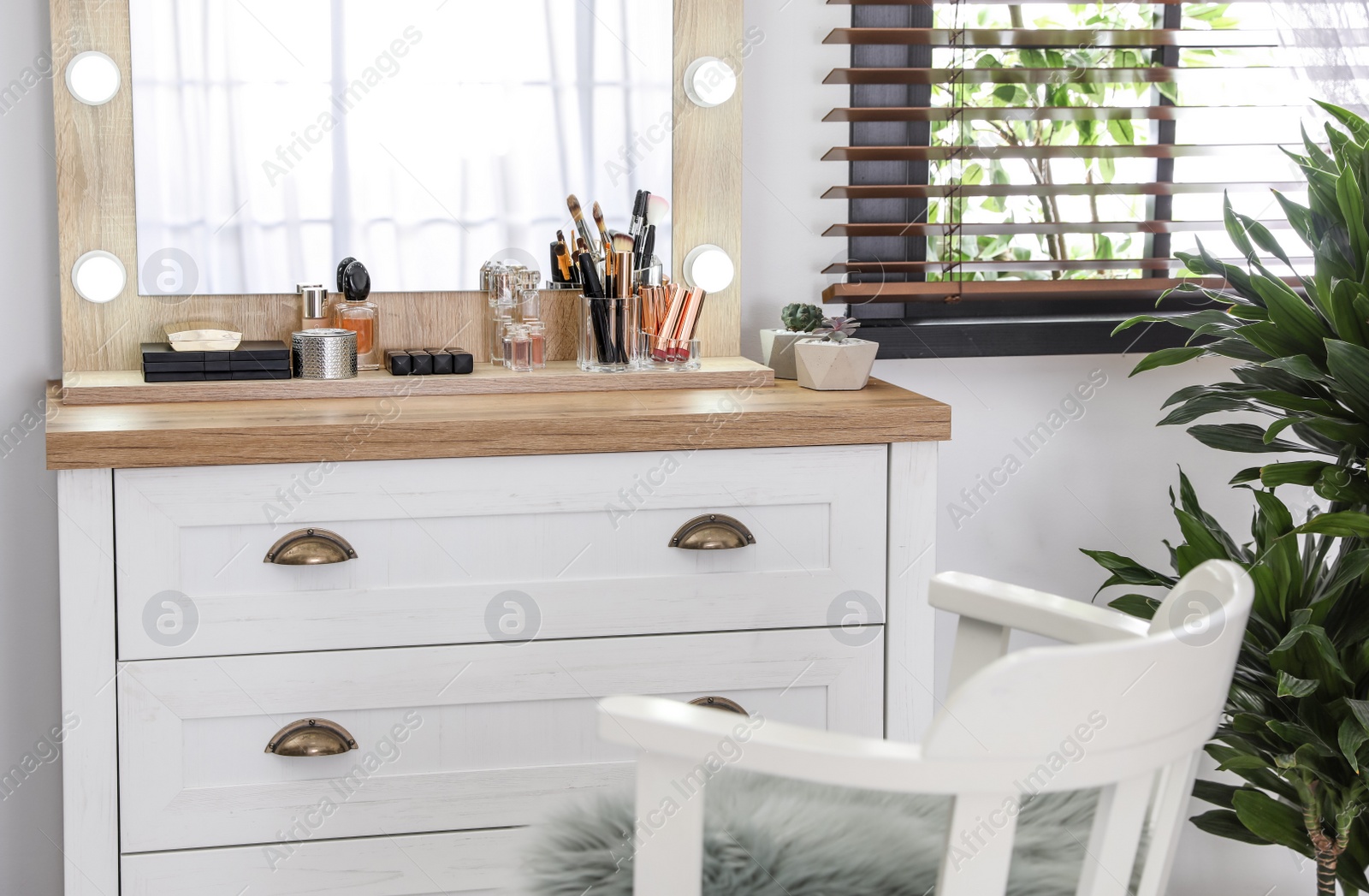 Photo of Dressing table with luxury cosmetics and accessories in room near window