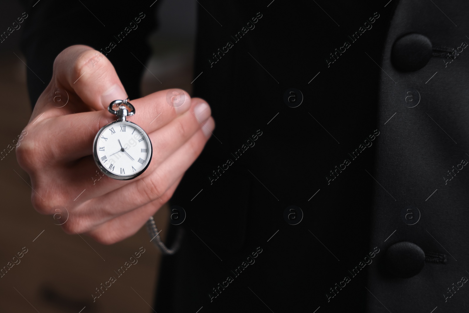 Photo of Man holding chain with elegant pocket watch, closeup