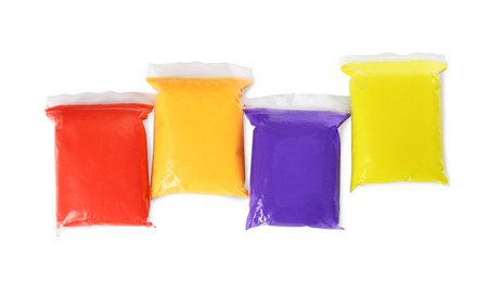 Packages of colorful play dough on white background, top view