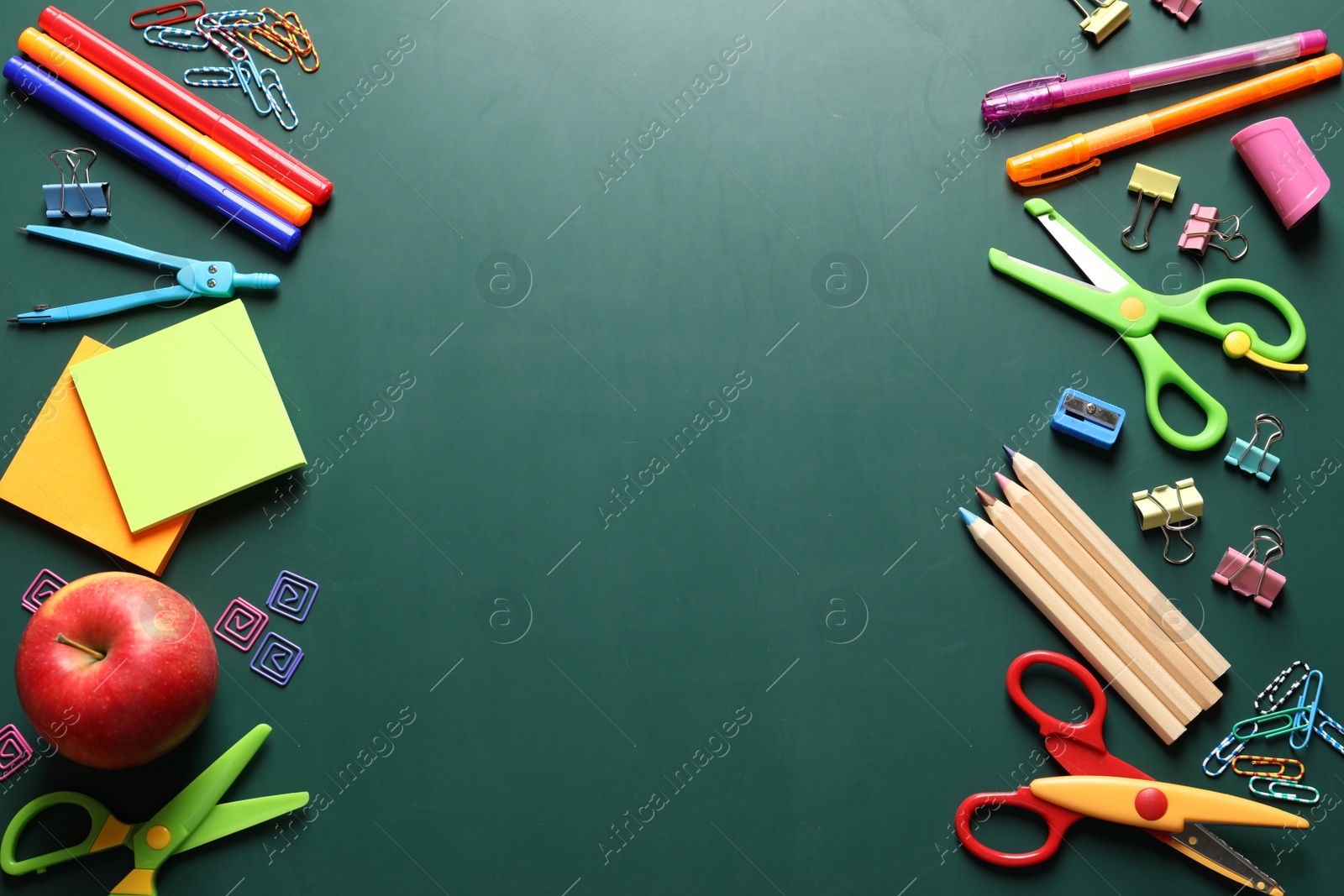 Photo of Flat lay composition with scissors and school supplies on chalkboard. Space for text