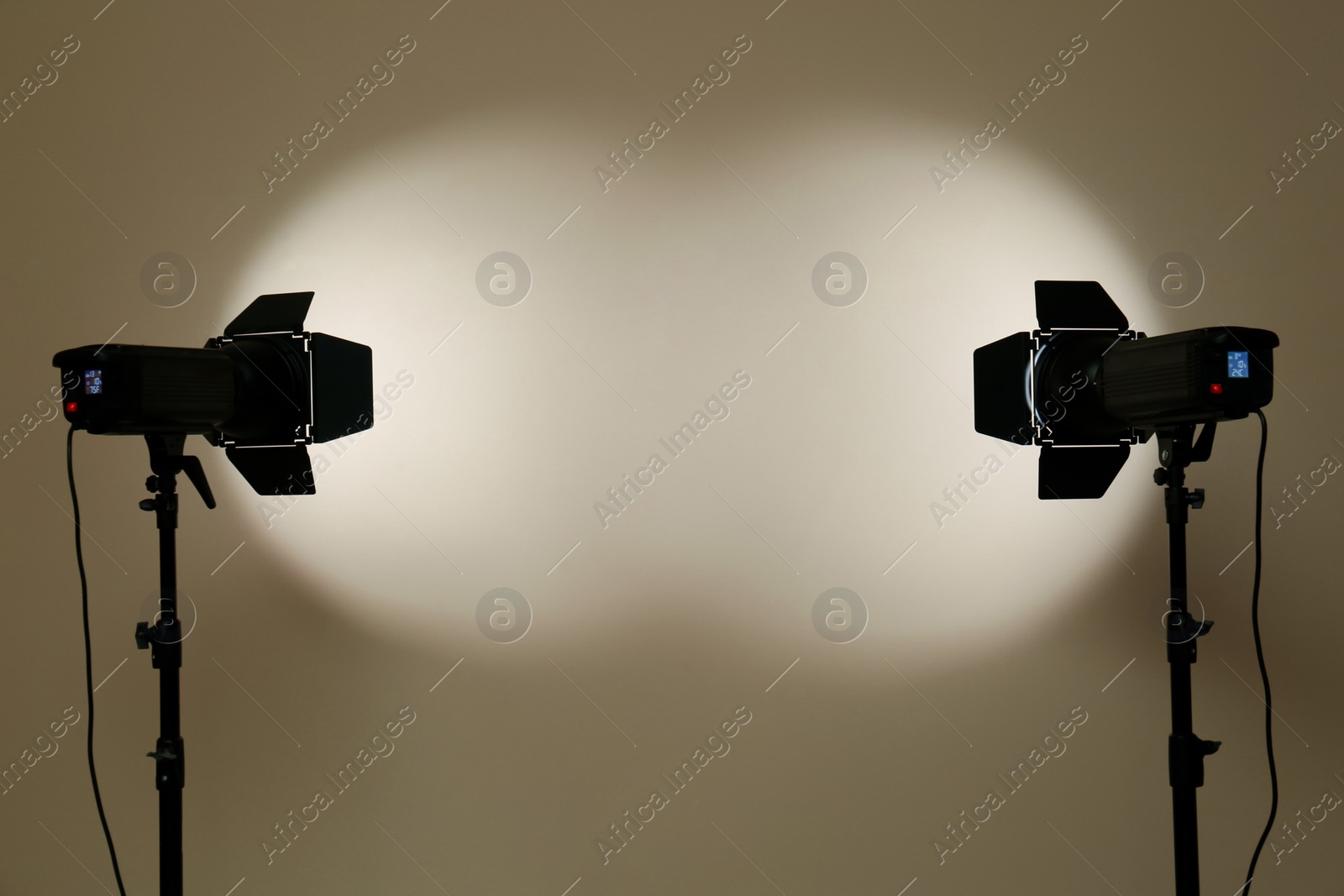 Photo of Modern spotlights against beige background, space for text