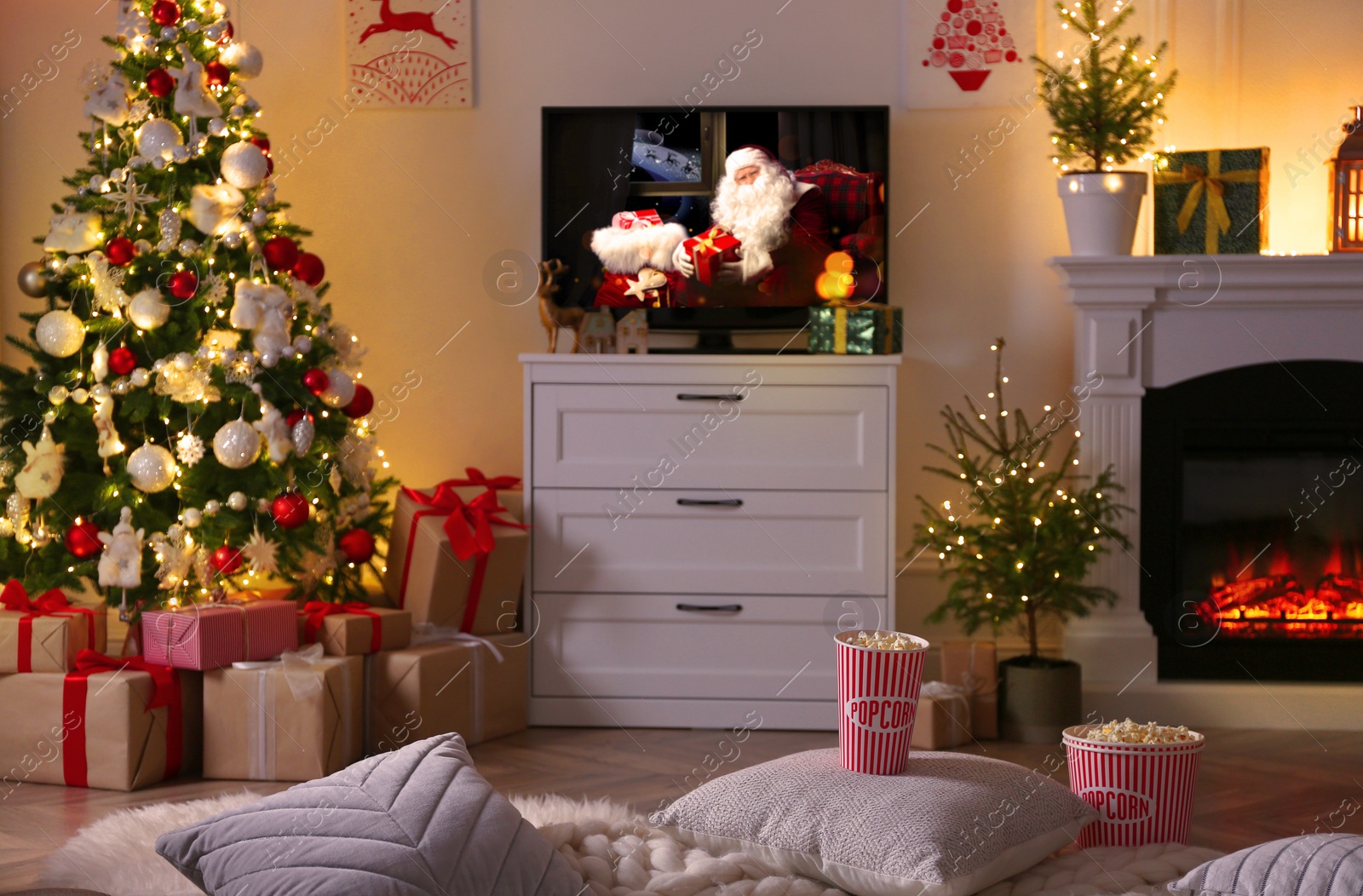 Image of Stylish living room interior with TV set, Christmas tree and fireplace