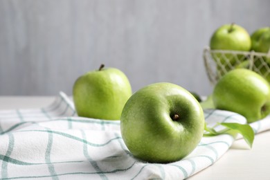 Photo of Fresh ripe green apples and napkin on table