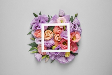 Photo of Flat lay composition with beautiful Eustoma flowers on grey background