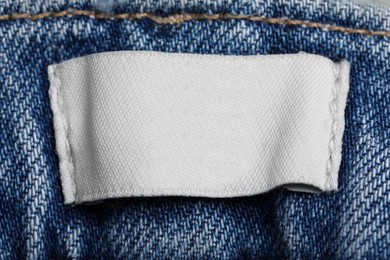 Empty clothing label on jeans garment, top view
