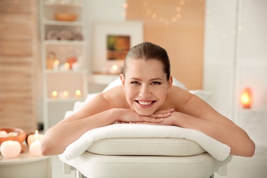 Photo of Beautiful young woman on massage table in spa salon