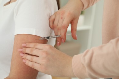 Photo of Diabetes. Woman getting insulin injection indoors, closeup