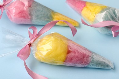 Packaged sweet cotton candies on light blue background