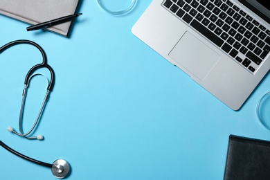 Photo of Modern laptop and medical students stuff on color background, top view. Space for text