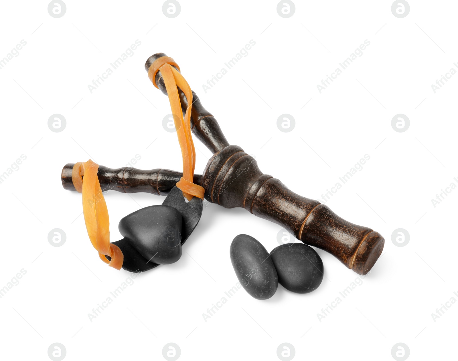 Photo of Black wooden slingshot with stones on white background