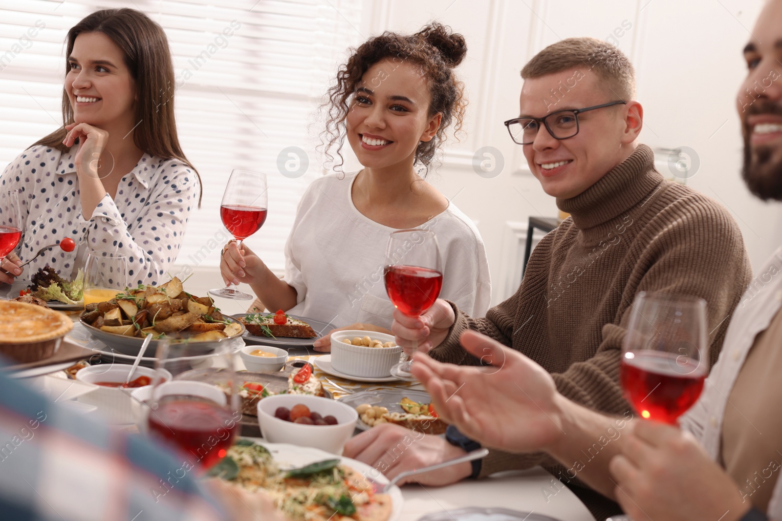 Photo of Group of people having brunch together at table indoors