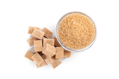 Photo of Different types of brown sugar and bowl isolated on white, top view