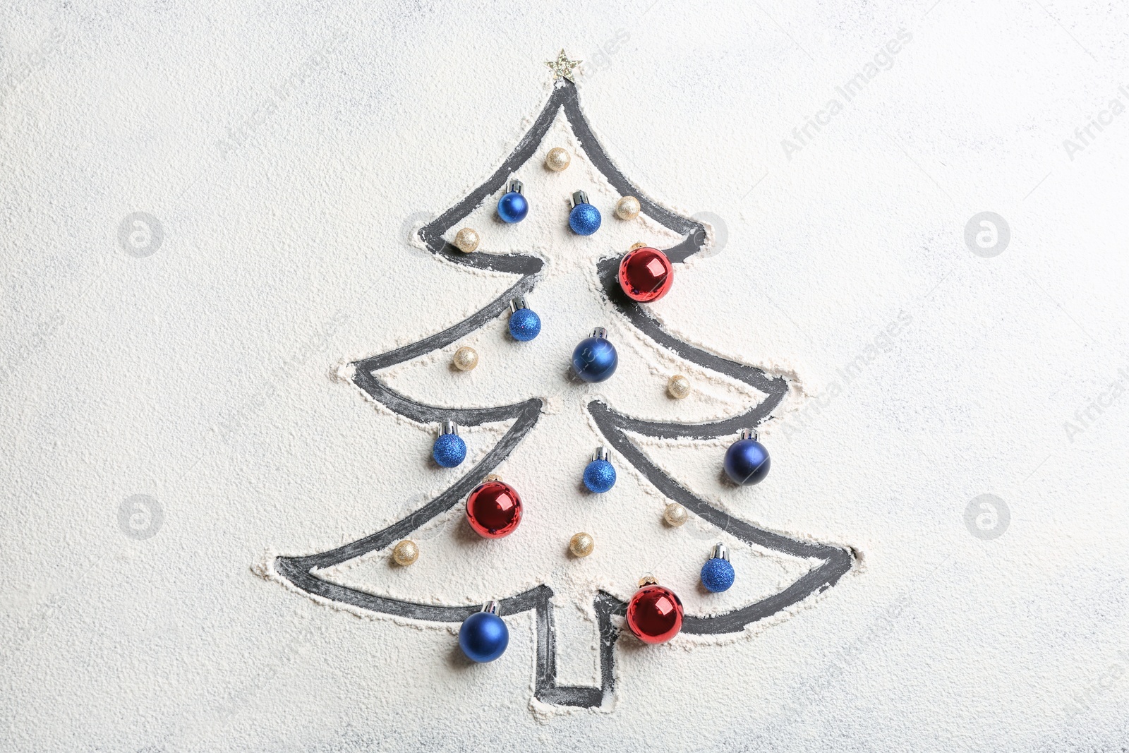 Photo of Christmas tree made of flour and festive decor on grey table, flat lay