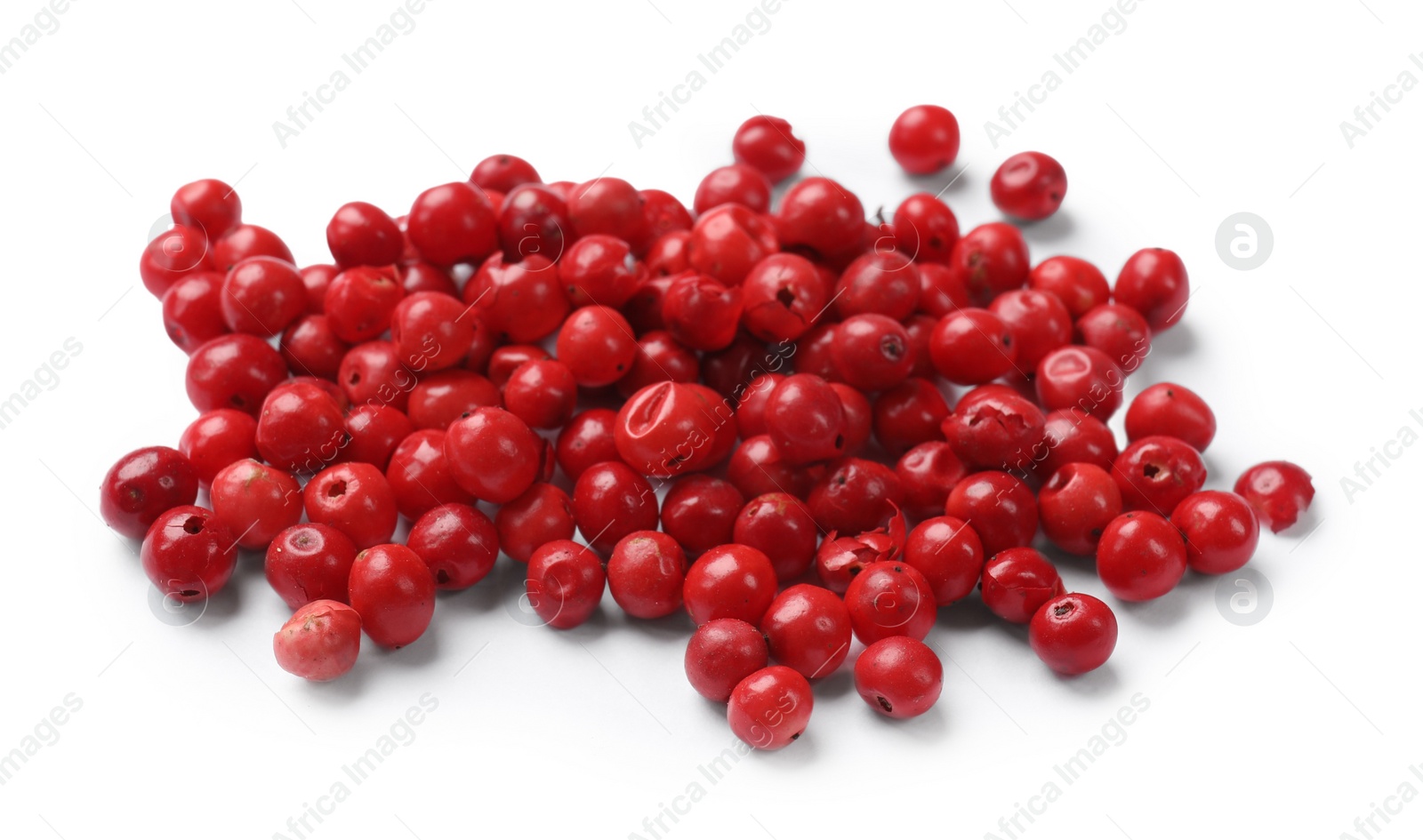 Photo of Aromatic spice. Many red peppercorns isolated on white