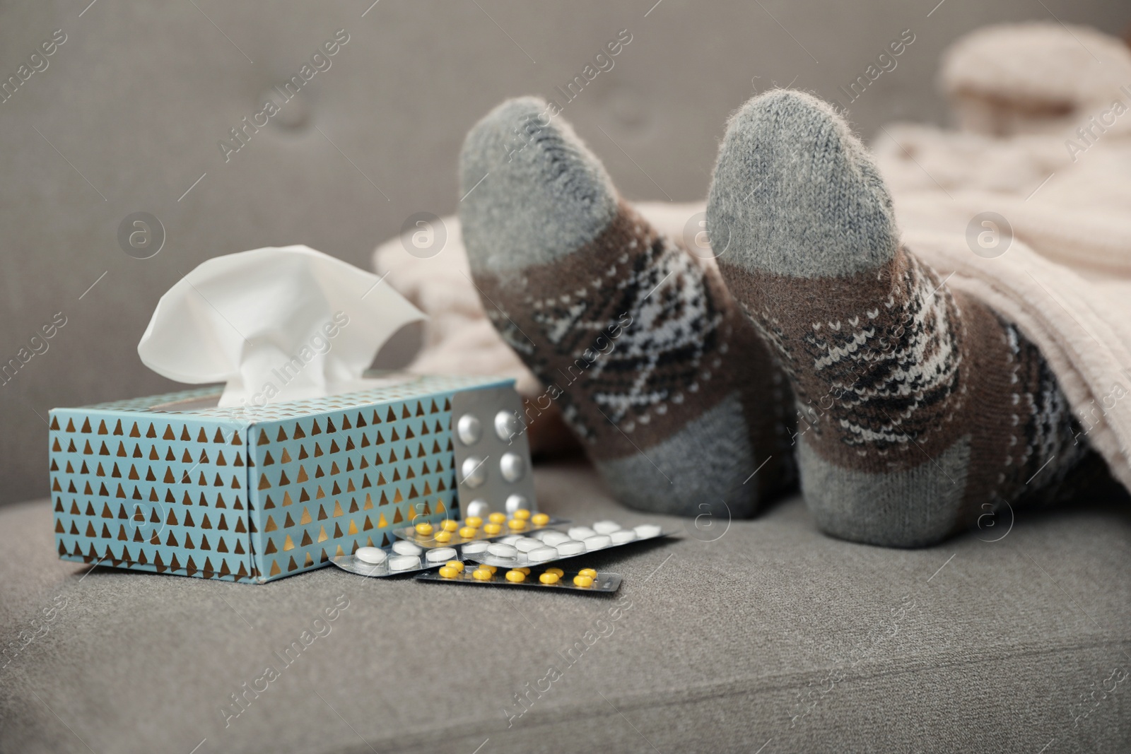 Photo of Mature woman and cold remedies on sofa, closeup. Dangerous virus