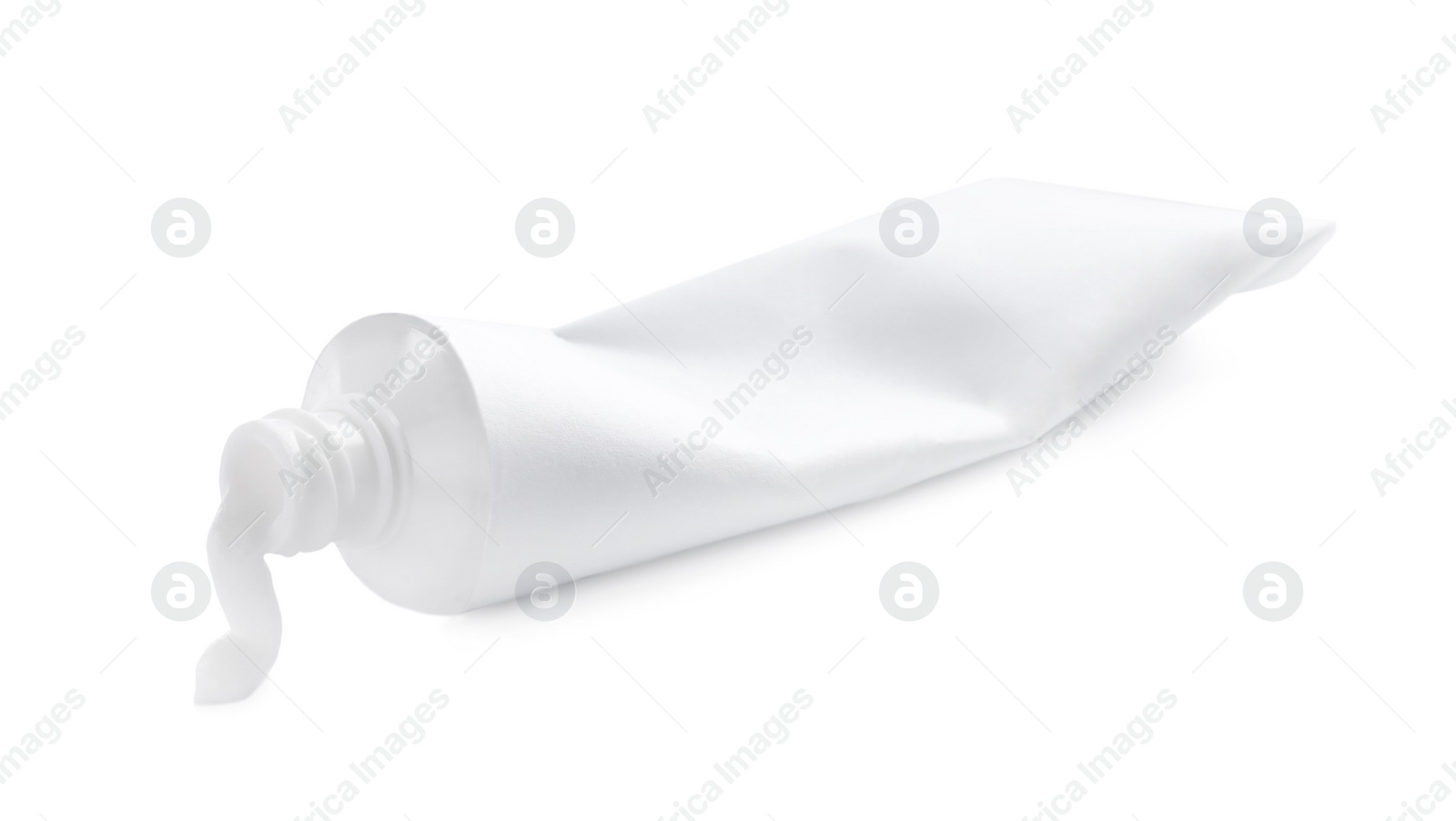 Photo of Blank tube and toothpaste on white background