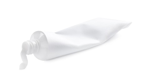 Photo of Blank tube and toothpaste on white background