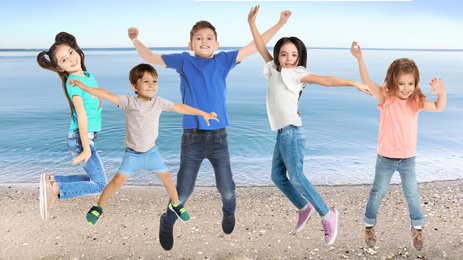 Image of Group of school children jumping on beach near sea. Summer holidays