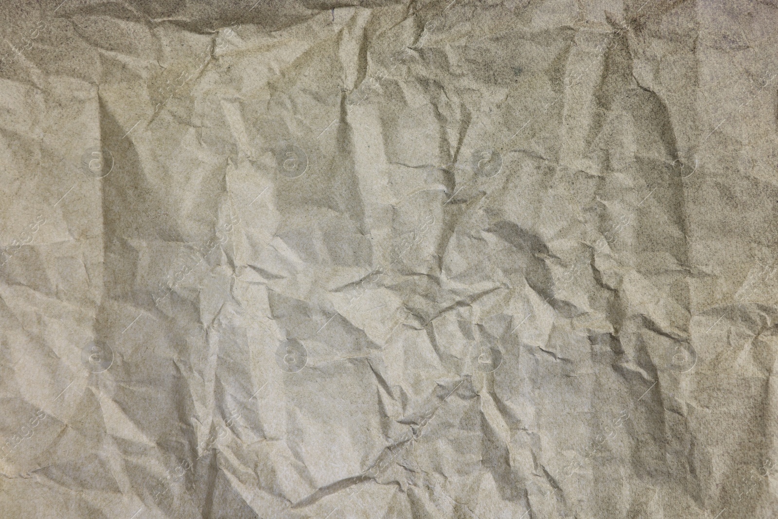 Photo of Texture of crumpled parchment paper as background, top view