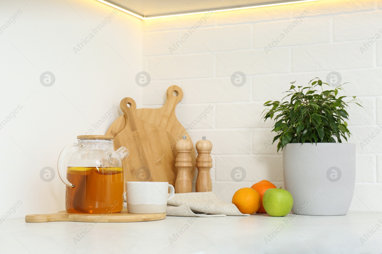 Photo of Different kitchen items and houseplant on countertop indoors