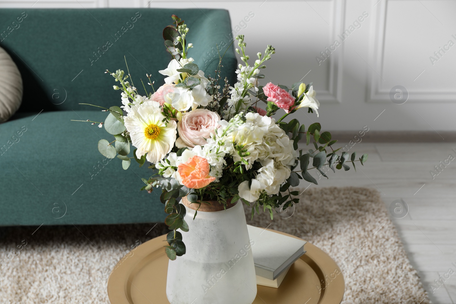 Photo of Bouquet of beautiful flowers on table indoors