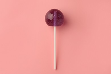 Tasty lollipop on pink background, top view