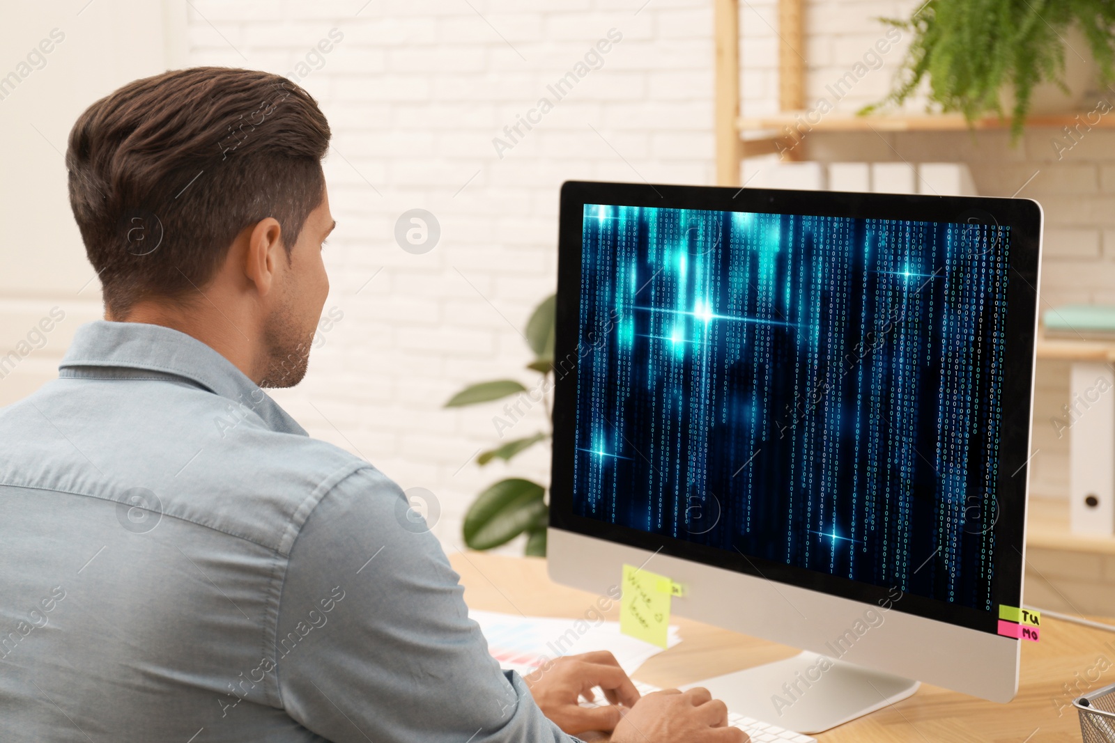 Image of Professional programmer working with computer in office