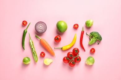 Flat lay composition with fresh vegetables and fruit on color background