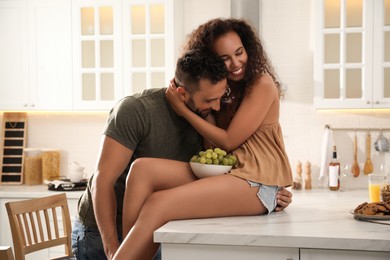 Photo of Lovely couple enjoying time together in kitchen at home