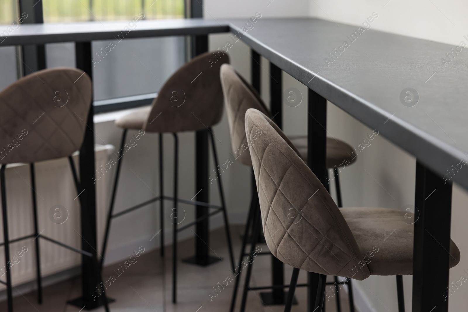Photo of Tables and bar stools in hostel dining room